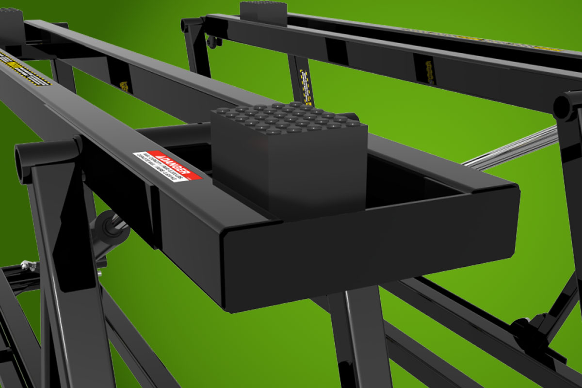QuickJack portable car lift with stacked rubber lift blocks protecting vehicle pinch welds